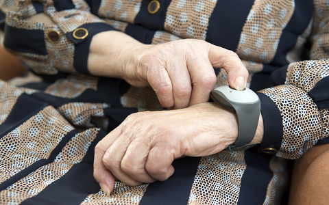 Women's hands with a tracking device